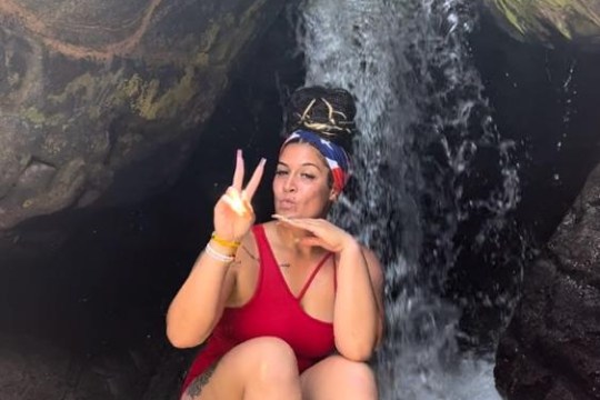 a woman sitting on a rock