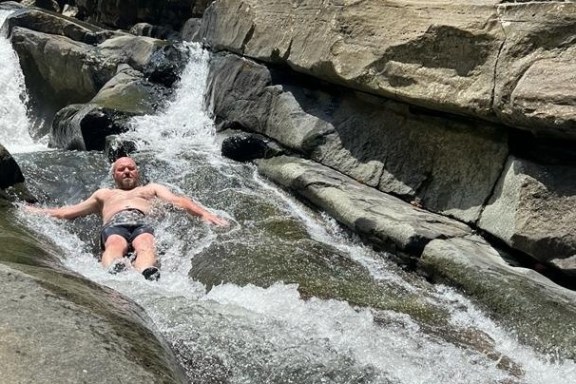 a man standing on a rock in a pool of water
