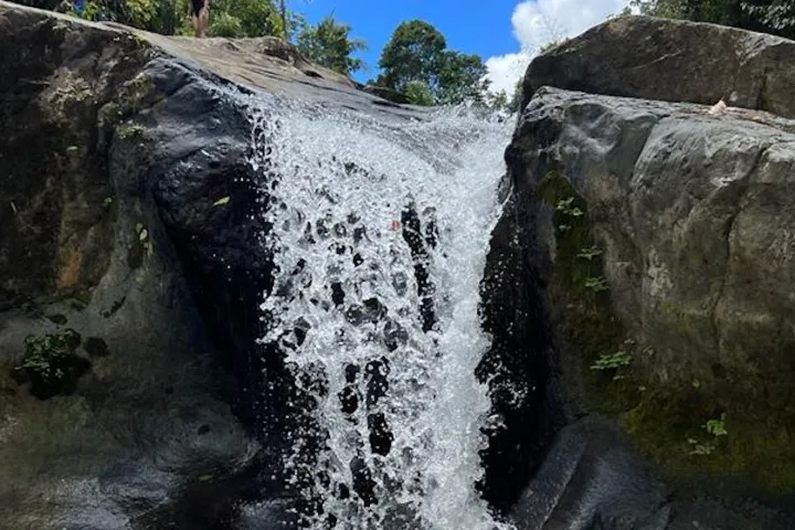 a large waterfall over a rocky cliff
