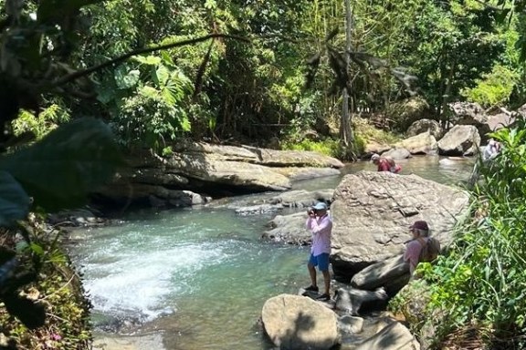 a man standing next to a river