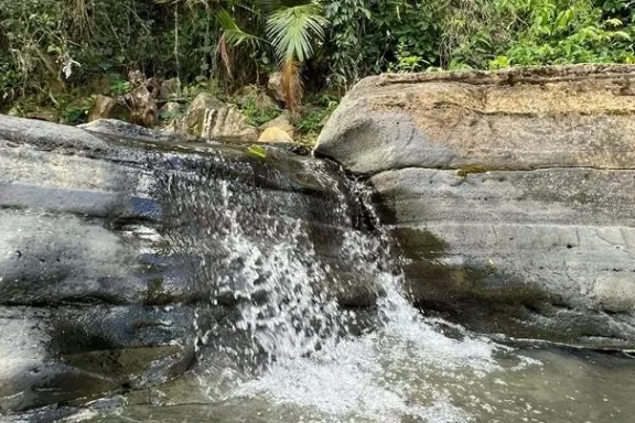 a large waterfall and a pool of water
