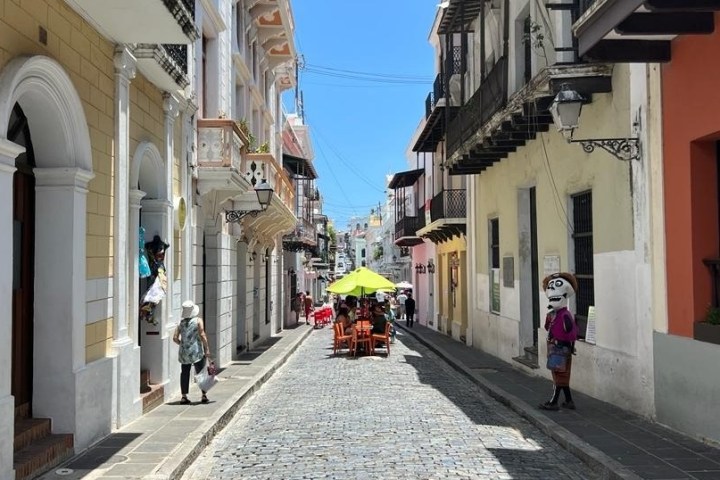 a person walking down a sidewalk in front of a building
