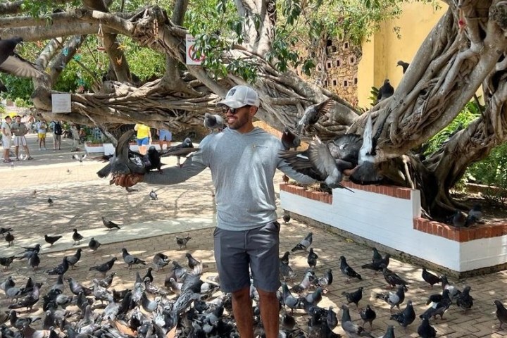 a group of people feeding a bird
