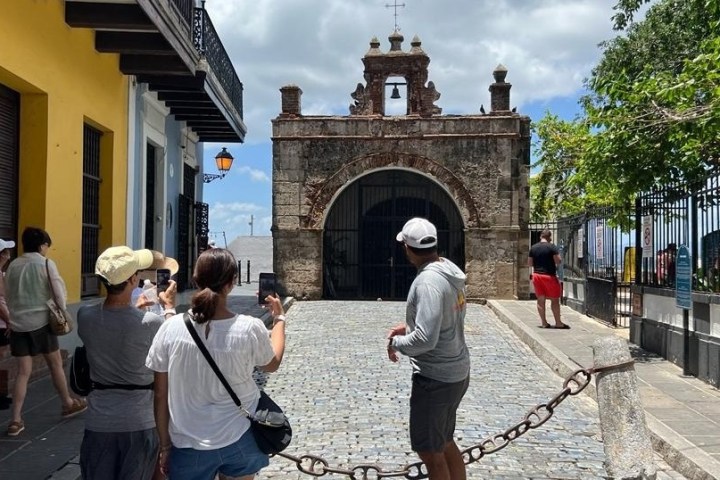 a group of people walking on a sidewalk