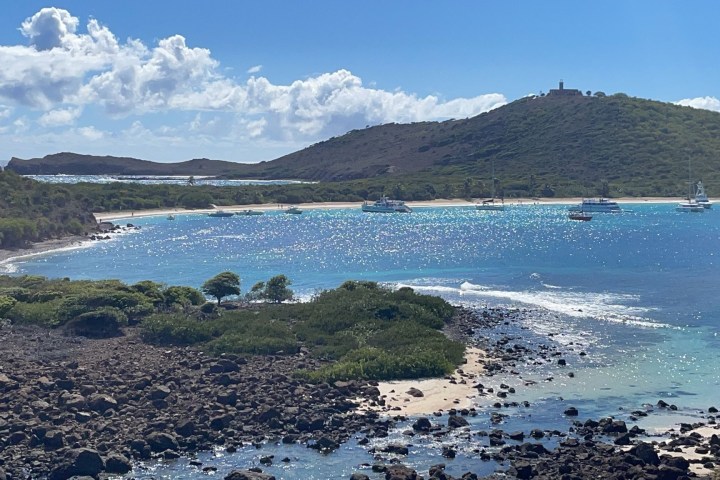 a group of people on a beach near a body of water